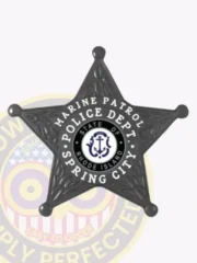 Spring City Police Marine Patrol badge in black metal shaped as a five-point star with a white circular banner reading "Marine Patrol Police Dept Spring City" around the Rhode Island emblem, secured by safety pin.