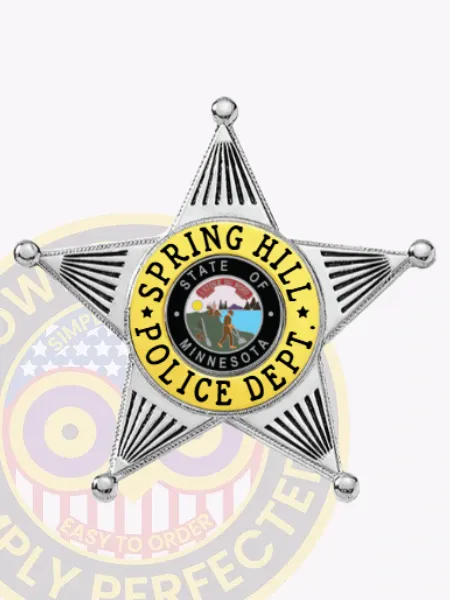 Five-point star silver metal badge for Spring Hill Police, showing clear black text in a yellow circular banner around the Minnesota state seal, finished with safety pin fastening.