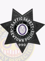 Black seven-point star metal badge customized for Newtown police the traffic safety unit, displaying detailed engraved foliage designs on each point, a central seal of Connecticut in purple and white, and white block letters encircling it with “Traffic Safety Newtown Police,” plus a safety pin attachment on the back.