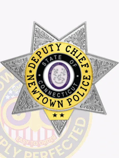 Custom silver 7 point star metal badge for Newtown police the deputy chief, showing a textured silver star with ornate leaf patterns, a black and purple state seal in the center, encircled by a yellow ring with the title “Deputy Chief Newtown Police” in black font and two stars below.