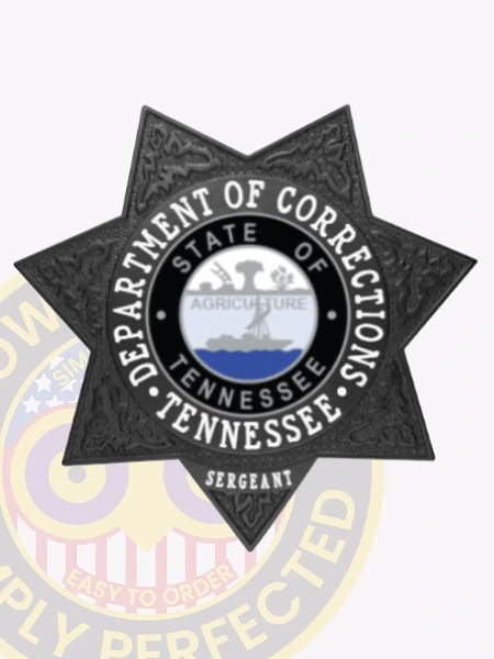 Custom metal badge in black with safety pin attachment, shaped like a star and designed for authority. The badge features the words "Department of Corrections" prominently displayed around a central circular emblem. Inside the circle, the state seal of Tennessee is depicted, showcasing an agricultural scene with blue water beneath. The text "State of Tennessee" encircles the emblem, while the word "Sergeant" is clearly marked at the bottom, indicating the rank. This badge represents a significant role within the corrections system, emphasizing duty and responsibility.