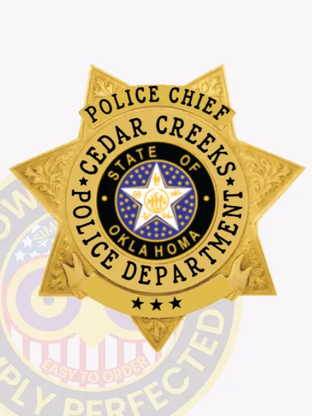 Cedar Creeks Police Chief custom gold 7 point star metal badge showing embossed floral designs on each point, a blue circular emblem with the Oklahoma state seal centered by a white star, clear black lettering around it, and three stars on a gold scroll at the bottom, attached by safety pin.
