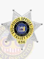 Custom silver 7 point star metal badge for Oak Valley police the police officer, showing a textured silver star with ornate leaf designs on each point, a central circular emblem featuring the New York state seal, and a vibrant yellow ring with black text reading “Police Officer Oak Valley Police” plus badge number “656.”