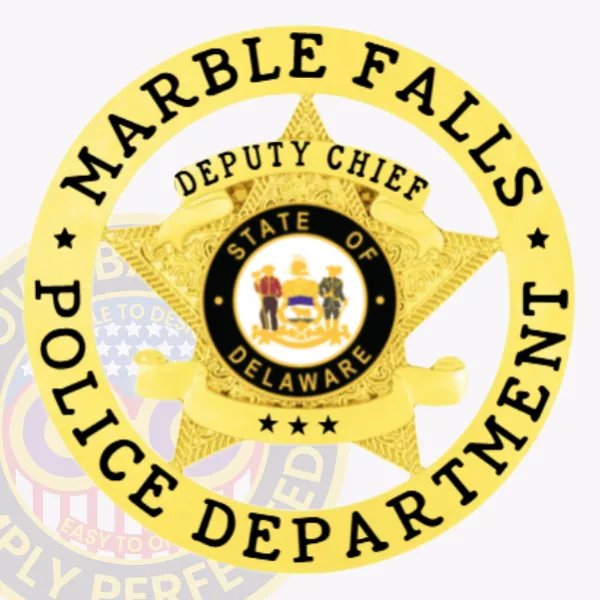 Custom gold metal badge featuring a detailed five-point star inside a circular banner reading "Marble Falls Police Department" in bold black letters, with a banner across the star labeled "Deputy Chief" and the State of Delaware seal centered, equipped with a safety pin attachment.