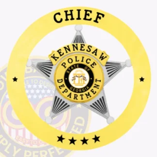Gold circle banner with bold black letters "Chief" and "Kennesaw Police Department," surrounding a silver five-point star badge with the State of Georgia emblem in the center, designed with a safety pin fastener.