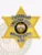 Gold custom 6 point star badge made for Hilltop City police lieutenant showing black text on silver banners, a central colored seal of the State of Iowa, and a safety pin fastener on the reverse side.