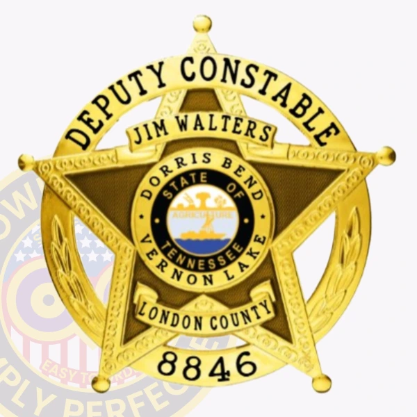 Close up of a custom metal badge in gold color with safety pin attachment, featuring a star design. The badge prominently displays "DEPUTY CONSTABLE" and the name "JIM WALTERS." In the center, it includes "DORRIS BEND, STATE OF TENNESSEE" alongside the emblem of Vernon Lake. The badge also features "LONDON COUNTY" and the number "8846," highlighting its official capacity and personal significance.