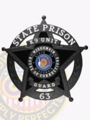Custom metal badge in black color with safety pin attachment featuring a star shape, inscribed with "STATE PRISON K9 UNIT" at the top. The center displays the state seal of Wisconsin, surrounded by the words "STATE OF WISCONSIN HOUSE OF CORRECTION." The badge includes a numeric designation "GUARD 63," emphasizing its official capacity. The safety pin attachment is visible, making it easy to fasten securely.