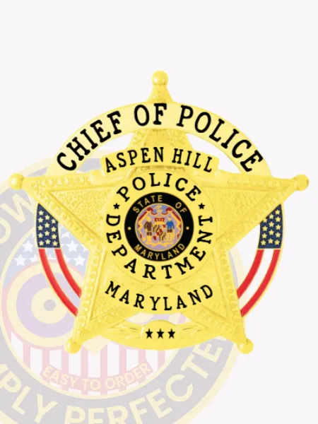 Aspen Hill Police Chief of Police badge in gold metal, shaped as a five-point star with "Chief of Police" curved banner, detailed Maryland state emblem in the middle, secured by a safety pin.