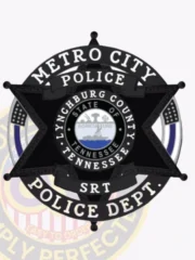 Dark black six-point star metal badge for Metro City police SRT unit, encircled by a silver ring with black text stating "METRO CITY POLICE DEPT.," adorned with black banners that say "POLICE" and "SRT," centered by the Tennessee state seal and county name, with a safety pin attachment on the back.