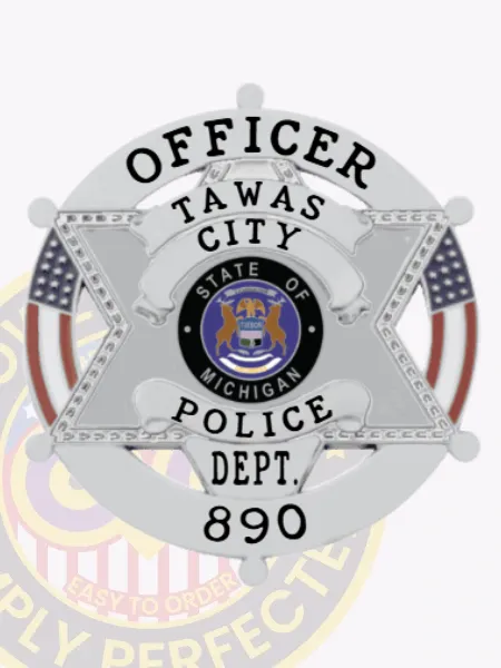 Silver six-point star metal badge for Tawas City Police Officer, displaying clear black lettering "Officer" in the circular banner and Michigan state emblem at the center, attached by safety pin.