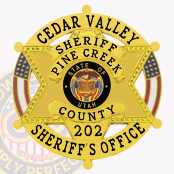 A close-up of a custom metal badge in a bright gold color, designed in the shape of a star, representing the Cedar Valley Sheriff's Office. The badge features the text "CEDAR VALLEY," "SHERIFF," and "PINE CREEK" prominently on the top, with "COUNTY 202" and "SHERIFF'S OFFICE" at the bottom. The center showcases the state seal of Utah, surrounded by decorative elements. It includes a safety pin attachment on the back, ensuring secure fastening for easy wear by law enforcement personnel.