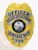 A custom metal badge in gold color is depicted here, adorned with elegant silver panels that read "Officer Police Department, Sunvale Bay." The badge features an intricate Florida state emblem and comes with a reliable safety pin attachment for easy application.