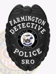 This image displays a polished custom metal badge in black, adorned with the inscription "STATE OF MAINE." The inclusion of a safety pin attachment provides a practical option for officials needing to showcase their identification while maintaining professionalism.