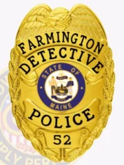 Highlighted is a custom metal badge in a radiant gold finish, showcasing the text "DETECTIVE POLICE" along with the emblem of the State of Maine. The safety pin attachment provides reliable security, making this badge ideal for law enforcement officials who require a stylish identification solution.