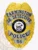A custom metal badge gleaming in gold is presented here, featuring "FARMINGTON" and "SR. DETECTIVE" above a central emblem. The inclusion of silver panels and a safety pin attachment allows for easy and secure wear, making it suitable for professionals in law enforcement.