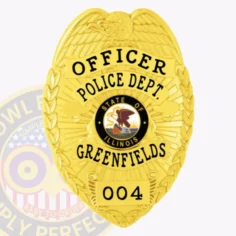 A custom metal badge in gold color is depicted here, featuring "officer police dept. Greenfields" prominently displayed. The badge showcases a central illinois state emblem and includes a safety pin attachment for easy application on uniforms.