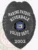 Riverdale Police Marine Patrol custom metal badge in matte black, featuring a prominent eagle design at the top, bold white text reading "MARINE PATROL," "RIVERDALE," and "POLICE DEPT." encircling the New York State seal in the center, with the date "2002" on a lower shield plate and a safety pin fastener on the back.