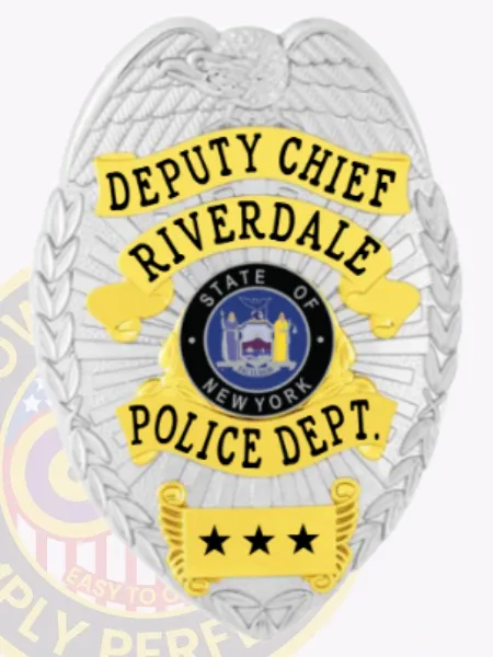Custom silver metal badge for Riverdale Police Deputy Chief featuring an embossed eagle on top, bold yellow ribbons displaying black text with "DEPUTY CHIEF," "RIVERDALE," and "POLICE DEPT.," centered around the official New York State seal, and a safety pin attachment on the back.