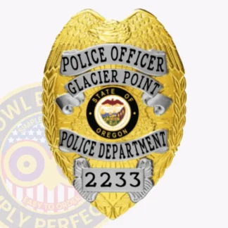 This detailed close up of a custom metal badge in gold color with silver panels featuring an eagle design at the top. The badge prominently displays the title "POLICE OFFICER" along with "GLACIER POINT POLICE DEPARTMENT" and the state seal of Oregon in the center. The badge number "2233" is clearly visible at the bottom, and it is designed with a safety pin attachment for secure fastening.