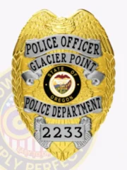 This custom metal badge in a gold color with sleek silver panels, displays "POLICE OFFICER GLACIER POINT POLICE DEPARTMENT" boldly at the top. The badge features the Oregon state seal and is equipped with a safety pin attachment for ease of use.