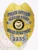 This custom metal badge in a gold color with sleek silver panels, displays "POLICE OFFICER GLACIER POINT POLICE DEPARTMENT" boldly at the top. The badge features the Oregon state seal and is equipped with a safety pin attachment for ease of use.