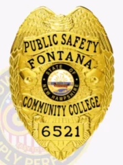 This custom metal badge in gold color with a safety pin attachment prominently displays "PUBLIC SAFETY," "FONTANA," and "COMMUNITY COLLEGE." The badge features a vibrant central emblem showcasing the New Hampshire state seal, surrounded by intricate golden detailing that signifies authority.