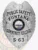 A striking custom metal badge in silver color with a safety pin attachment highlights the titles "PUBLIC SAFETY" and "FONTANA." The design includes a colorful depiction of the New Hampshire state seal at the center, framed by elegant silver accents.