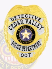 Showcasing an elegant custom metal badge in gold with silver panels, this design highlights the title "Detective Cedar Valley." The badge features an intricate Oklahoma state emblem and is equipped with a safety pin attachment for convenience.