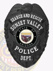A stunning black custom metal badge showcasing bold lettering for "SEARCH AND RESCUE" at the top. The badge features "SUNSET VALLEY POLICE DEPT." and the Arizona state seal prominently in the center. It is equipped with a safety pin attachment for practical use.