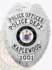 Detailed custom silver badge for Maplewood Police Officer, featuring an eagle at the top, black bold text "POLICE OFFICER POLICE DEPT." around the New Jersey state seal, "MAPLEWOOD" beneath it, and a number plate "1001," attached with a safety pin.