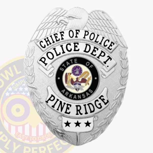 This striking custom metal badge shines in silver, highlighting "Chief of Police" and "Police Dept." at the top. The center of the badge showcases the emblem of Arkansas, enclosed within a black circle, with "Pine Ridge" clearly displayed below. A safety pin attachment ensures reliable placement on clothing.