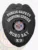 Featuring a custom metal badge in black color with a safety pin attachment, this badge emphasizes "PUBLIC SAFETY," "SHOPPING CENTER," and "K9." The centerpiece showcases a prominent circular emblem with the state seal, enhancing its authoritative appearance.