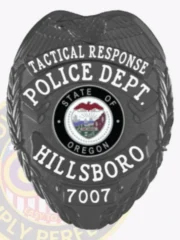 Custom black eagle top metal badge for Hillsboro Police Tactical Response, featuring white text on black banners reading "TACTICAL RESPONSE," "POLICE DEPT.," "HILLSBORO," and the badge number "7007," surrounding a colorful Oregon state seal in the center, with a detailed black eagle at the top and a safety pin attachment.