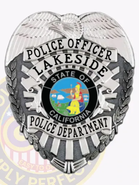 Custom silver metal badge for Lakeside Police Officer with a raised eagle design at the top, silver plates with black text naming the position and department, framing the official California state seal in the center, equipped with a safety pin fastening.