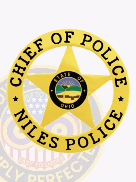 Niles Police Chief of Police badge in custom gold metal, shaped as a 5 point star inside a gold circle banner displaying "CHIEF OF POLICE" above and "NILES POLICE" below in black letters, with the central gold star showing the Ohio state seal and police department name, secured by a safety pin.