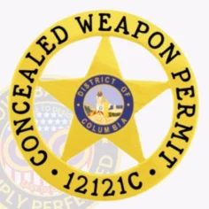This image showcases a custom metal badge in a vibrant gold color, shaped like a star and prominently displaying "concealed weapon permit. " the badge features the text "district of columbia" in the center and includes an identification number "12121c," making it an official credential for concealed carry.
