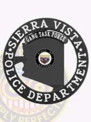 Black Arizona state metal badge for Sierra Vista Police Gang Task Force, featuring the state seal inside the silhouette, encircled by a bold black ring with white “Sierra Vista Police Department” text, and a black “Gang Task Force” label above, attached with a safety pin.
