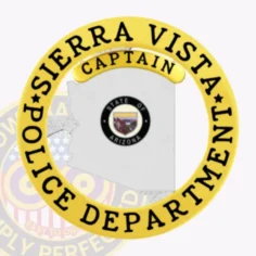Silver metal badge shaped like arizona for sierra vista police captain, displaying the arizona state seal inside the silver state outline, encircled by a shiny gold ring with bold black lettering “sierra vista police department,” topped with a gold captain banner, secured by a safety pin.