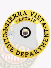 Custom silver Arizona badge for Sierra Vista Police Captain, showing the detailed Arizona state seal centrally placed within the silver state silhouette, bordered by a gold circular band with black text “Sierra Vista Police Department,” and a gold “Captain” label above, attached with a safety pin.