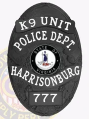 Detailed black oval metal police badge for Harrisonburg K9 Unit featuring the Virginia state seal at its center, bordered by white text stating "K9 UNIT," "POLICE DEPT.," "HARRISONBURG," and number "777," designed with a safety pin attachment.