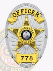 Detailed custom silver oval metal badge for Clearwater police officer with radiant silver sunray texture surrounding a central gold five-point star framing the colorful Florida seal, bold black text OFFICER on a curved gold banner at the top, CLEARWATER POLICE DEPT. inside the star, and numeric ID 778 on a gold plaque at the bottom; secured by safety pin.