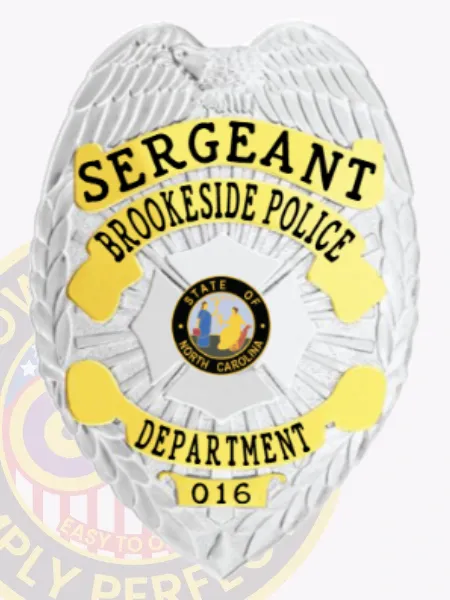 A vivid representation of a custom metal badge in silver with gold panels, designed for law enforcement. The badge reads "SERGEANT" and includes "BROOKESIDE POLICE" and "DEPARTMENT," along with the state seal of North Carolina and identification as part of the department with badge number 016. The safety pin attachment is highlighted for secure and convenient wear.