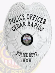 Cedar Rapids police officer’s metal badge in shiny silver showing a sculpted eagle spreading wings at the top, clearly printed black words POLICE OFFICER and CEDAR RAPIDS above a central State of Iowa seal in color, POLICE DEPT. and 808 below, with a safety pin on the back for secure attachment.