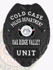 An elegant portrayal of a custom metal badge in black, marked with the title "COLD CASE" and the designation "POLICE DEPARTMENT." It prominently features the state emblem of Georgia and identifies as part of the Oak Ridge Valley with the word "UNIT" at the bottom. The safety pin attachment is highlighted, emphasizing its practical use.