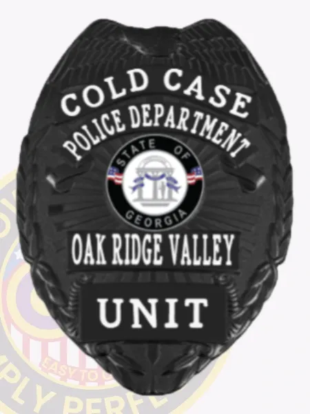 An elegant portrayal of a custom metal badge in black, marked with the title "COLD CASE" and the designation "POLICE DEPARTMENT." It prominently features the state emblem of Georgia and identifies as part of the Oak Ridge Valley with the word "UNIT" at the bottom. The safety pin attachment is highlighted, emphasizing its practical use.