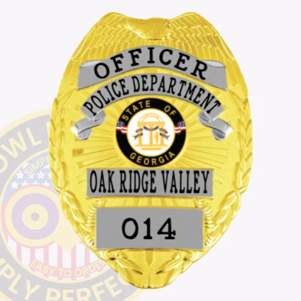 A vivid representation of a custom metal badge in gold with silver panels, designed for law enforcement. The badge reads "OFFICER" and includes "POLICE DEPARTMENT," along with the state seal of Georgia and the designation "OAK RIDGE VALLEY" with badge number 014. The safety pin attachment is highlighted for secure and convenient wear.
