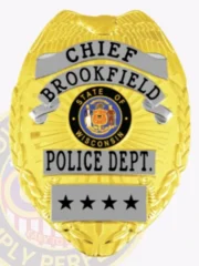 Shiny gold metal badge for Brookfield Police Chief featuring an embossed eagle on top, silver banners with clear black lettering of "CHIEF," "BROOKFIELD," and "POLICE DEPT.," surrounding the detailed Wisconsin state seal, completed with four black stars on a silver lower ribbon and a velcro attachment.