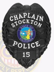 This elegant custom metal badge in black color with a safety pin attachment showcases the words "CHAPLAIN," "STOCKTON," and "POLICE." The badge's centerpiece features a prominent emblem of the California state seal, symbolizing commitment to public service and community support.