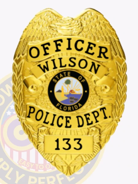 Wilson Police custom gold metal officer badge with an eagle crest, prominent black text "OFFICER WILSON POLICE DEPT." around the Florida state emblem, and a bottom number "133," equipped with a safety pin for attachment.